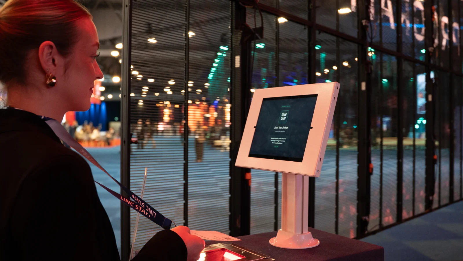 Attendee scanning their badge at a CME check-in kiosk at LINC 2026
