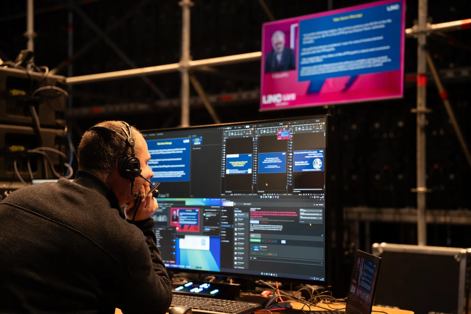 A technician in the master control room managing live presentations through the Slideshow City interface at LINC 2026